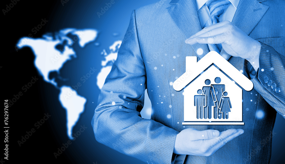businessman protecting family in home with hands