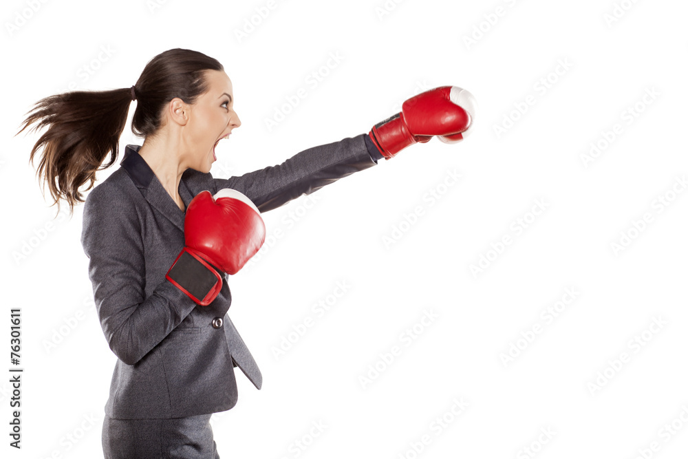 Profile of angry business woman, attack with boxing gloves