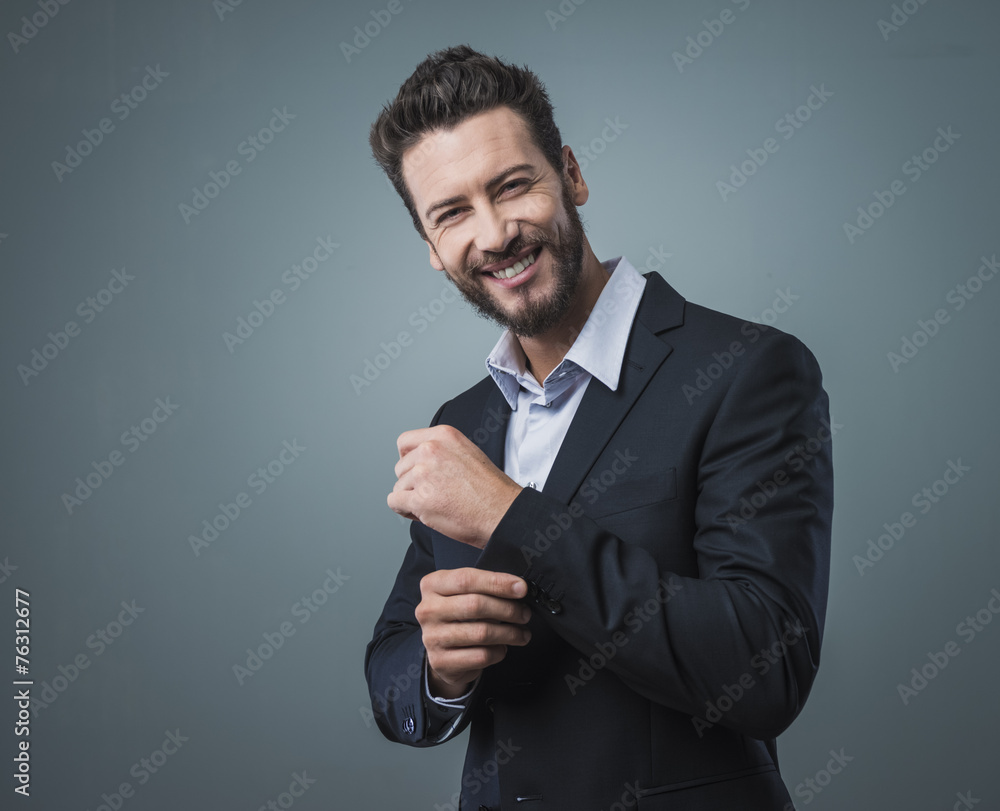 Elegant young man adjusting his jacket Elegant young man adjusting his jacket