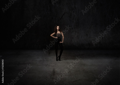 model posing in a dark room