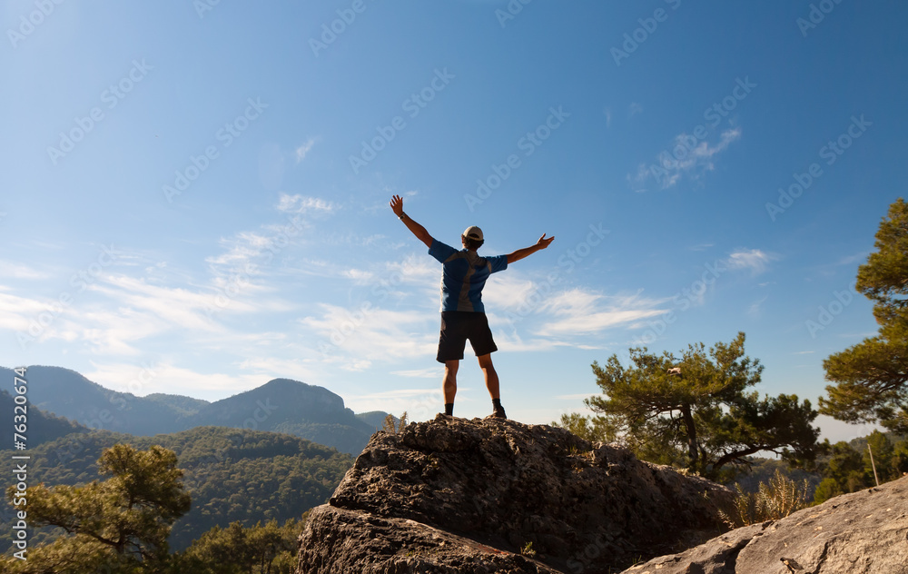 Sportsman on the top of rock. Sport and active life concept Sportsman on the top of rock. Sport and active life concept