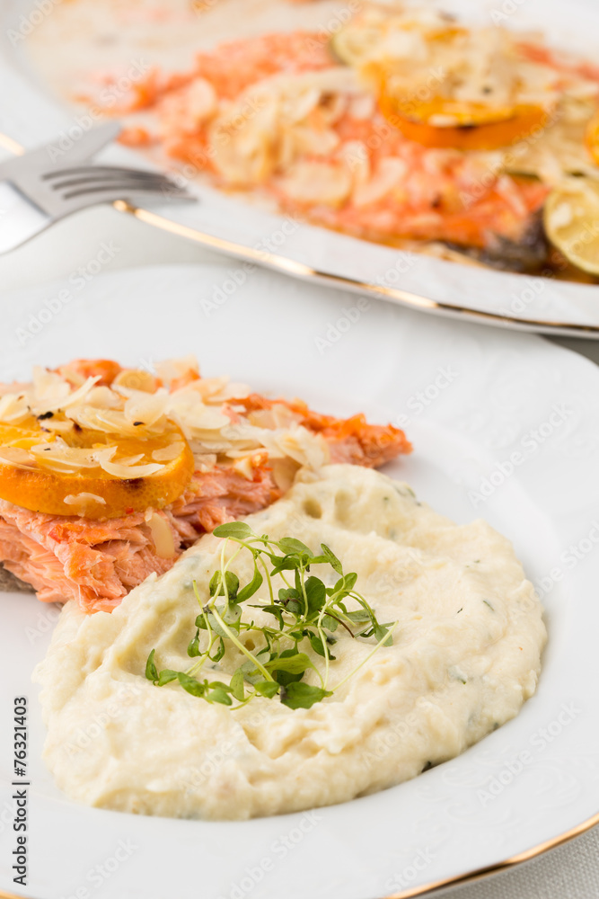 closeup of mashed potatoes with green leafs and salmon closeup of mashed potatoes with green leafs and salmon