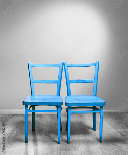 two blue chairs in the grey room