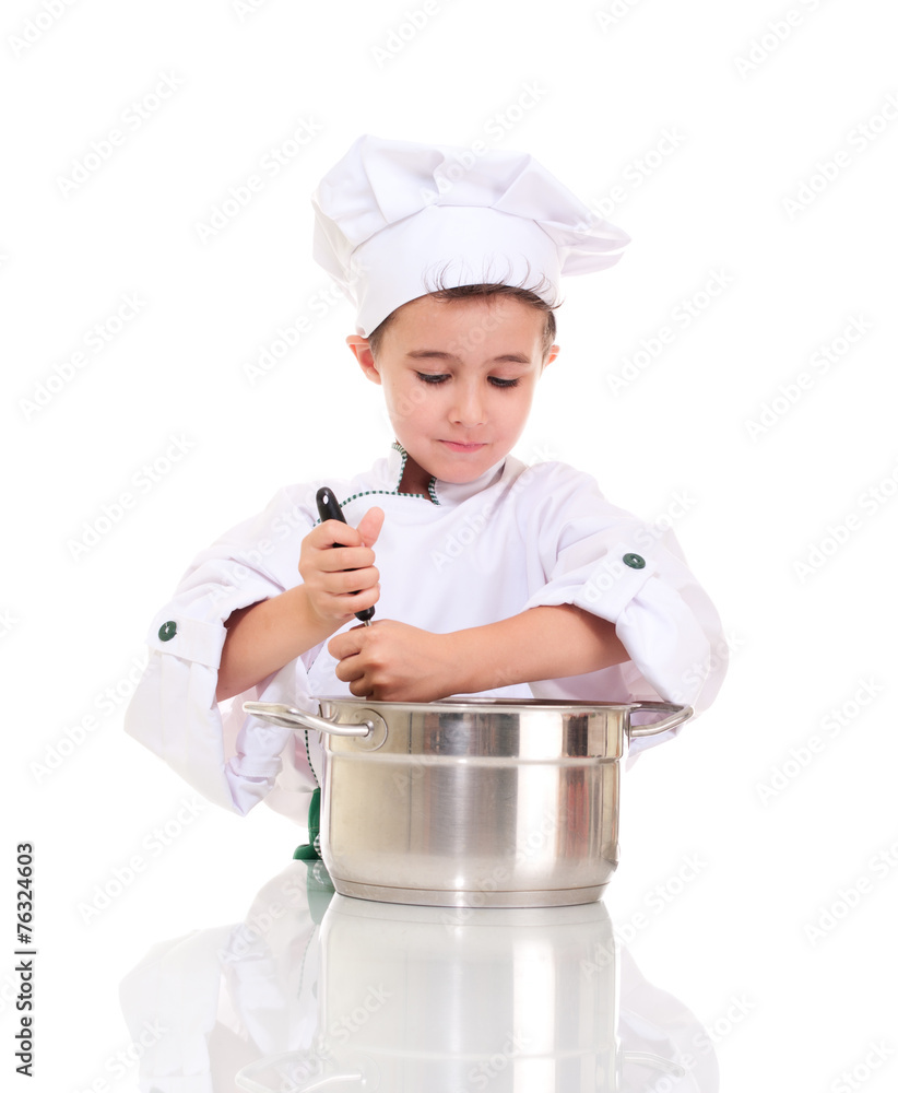 Little boy chef with ladle stirring in the pot Little boy chef with ladle stirring in the pot
