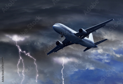 Quadro su tela Passenger air plane approaching thunder storm