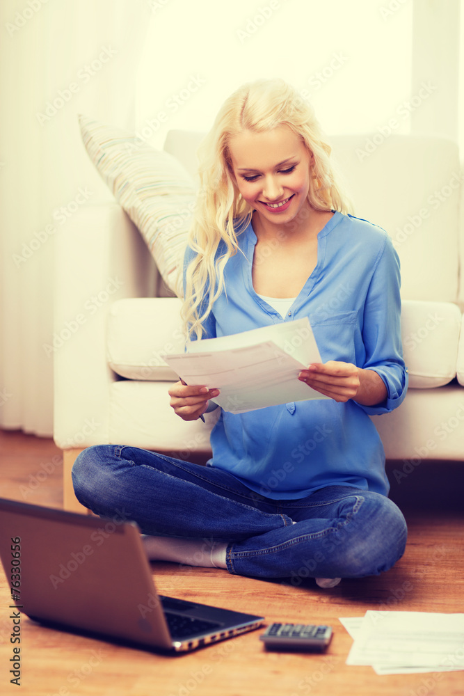 smiling woman with papers, laptop and calculator smiling woman with papers, laptop and calculator