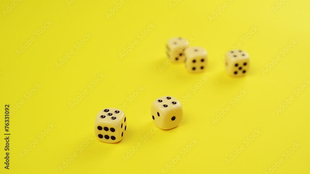 Rolling Dice on Yellow Background as Gambling Concept Rolling Dice on Yellow Background as Gambling Concept