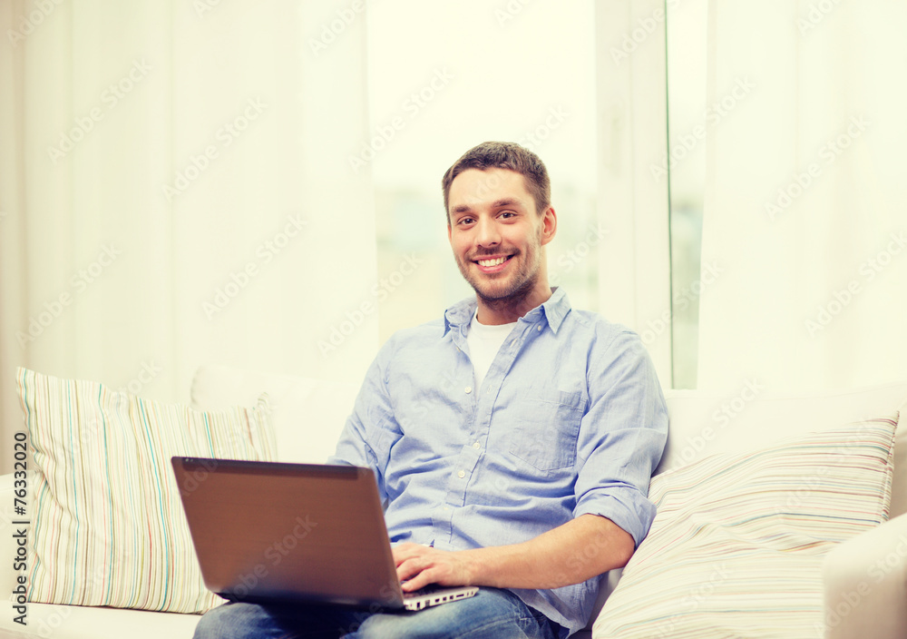 smiling man working with laptop at home smiling man working with laptop at home