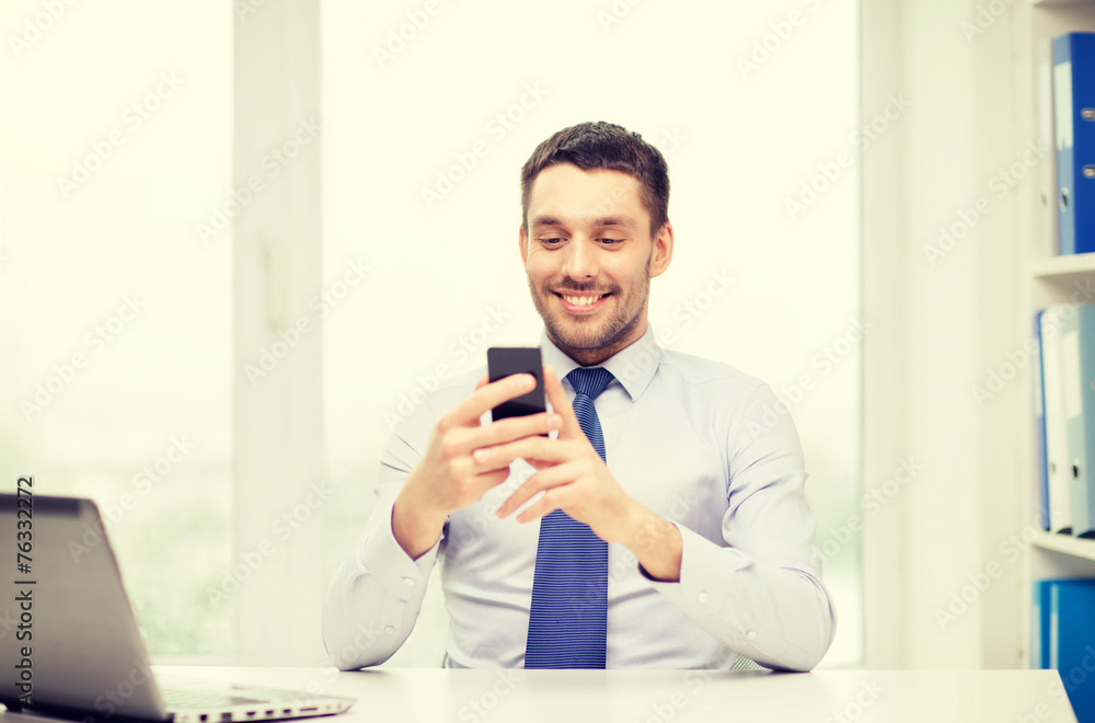 businessman with laptop and smartphone at office businessman with laptop and smartphone at office