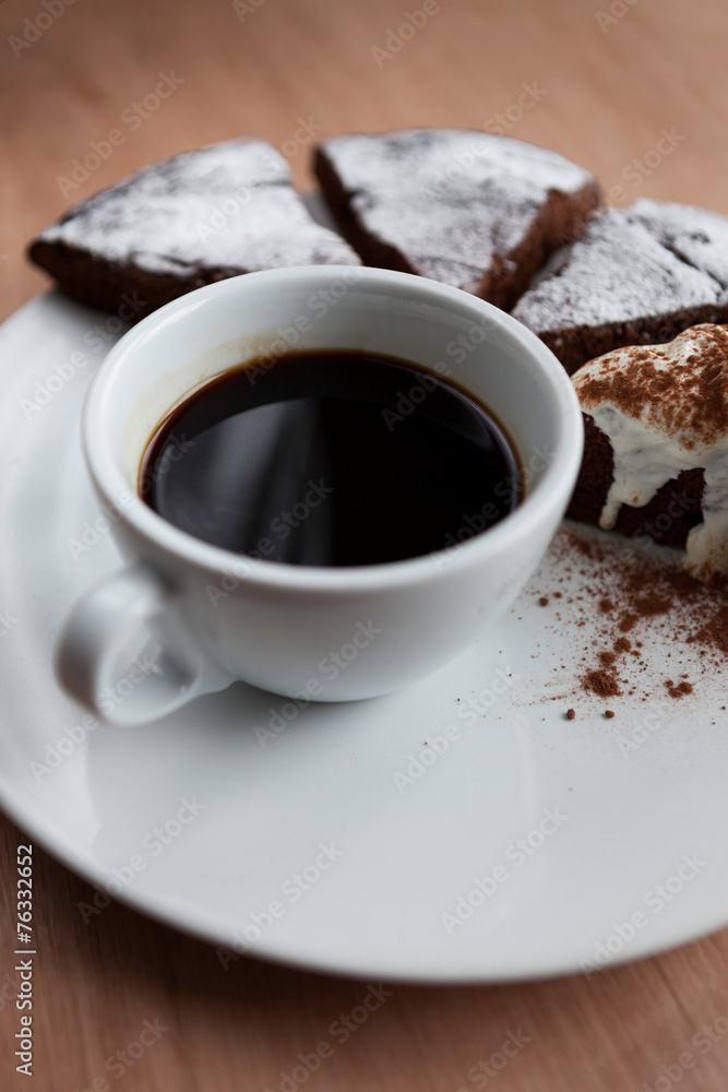 Closeup of a cup of black coffee with chocolate cake Closeup of a cup of black coffee with chocolate cake