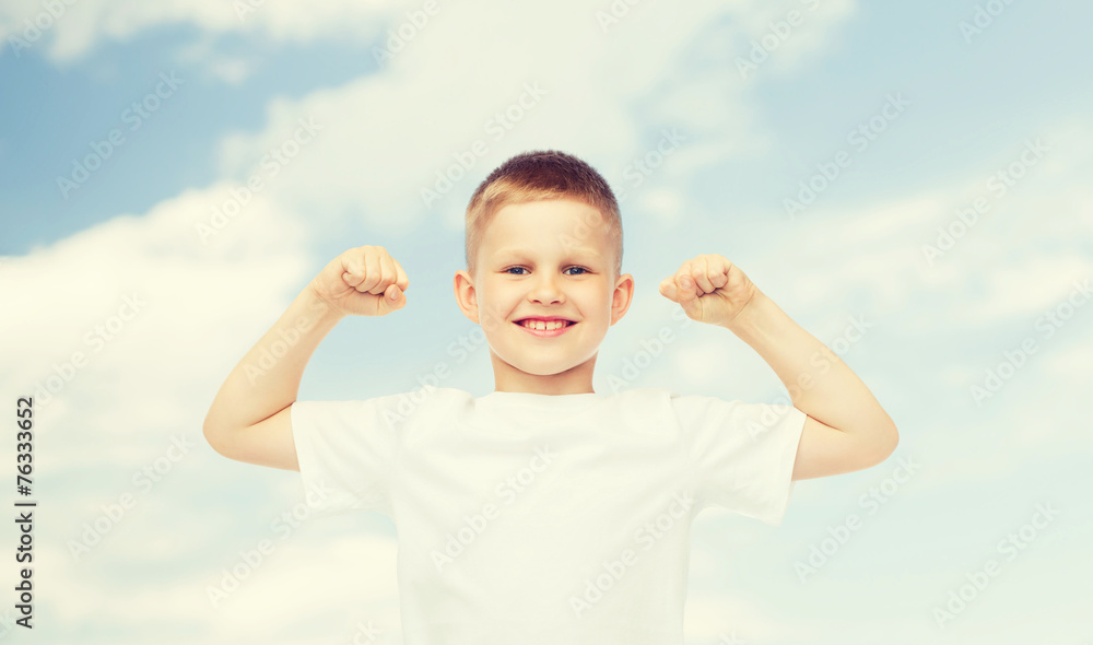 happy little boy in white t-shirt flexing biceps happy little boy in white t-shirt flexing biceps