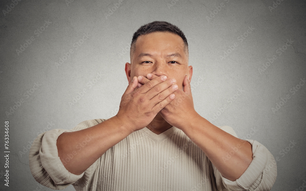 headshot young man student worker employee covering his mouth headshot young man student worker employee covering his mouth