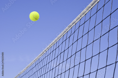 Yellow Tennis Ball Flying Over the Net © Orlando Bellini