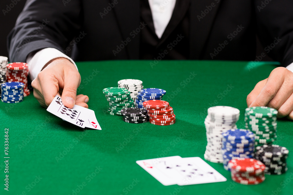 poker player with cards and chips at casino poker player with cards and chips at casino