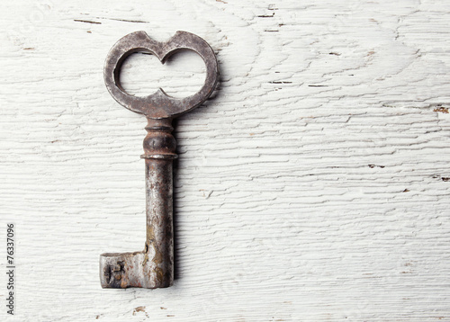 Old key on wooden table © Maksim Kostenko