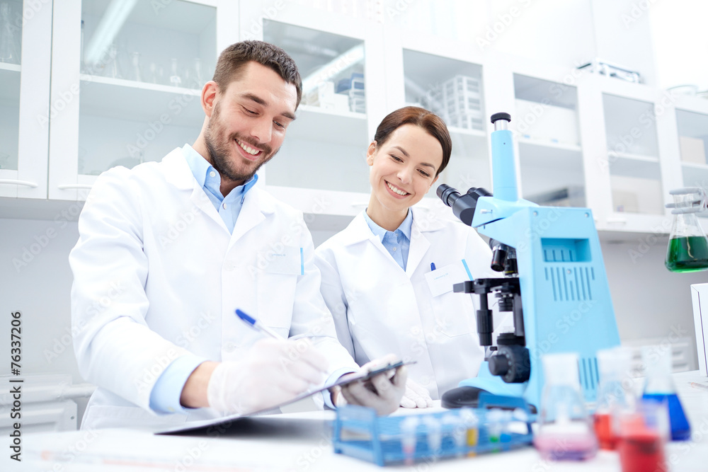 scientists with clipboard and microscope in lab scientists with clipboard and microscope in lab