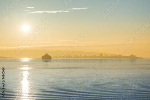 Cargo ship at sunset in the sea