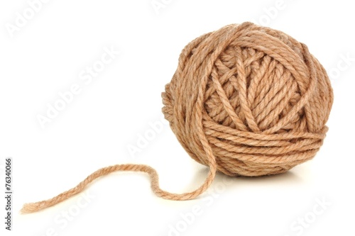 Ball of beige colored yarn isolated on white