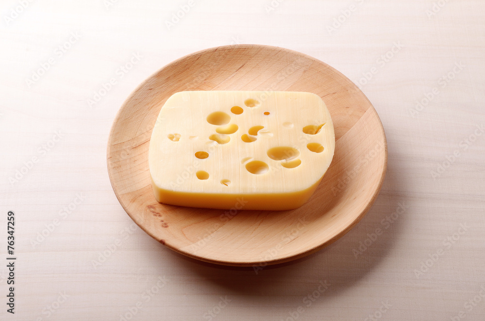 Cheese on wooden plate Cheese on wooden plate