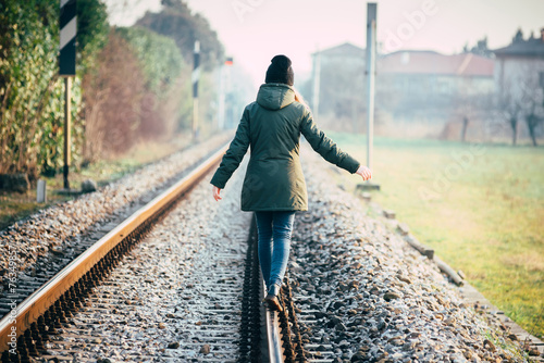 Girl walking on rail photo