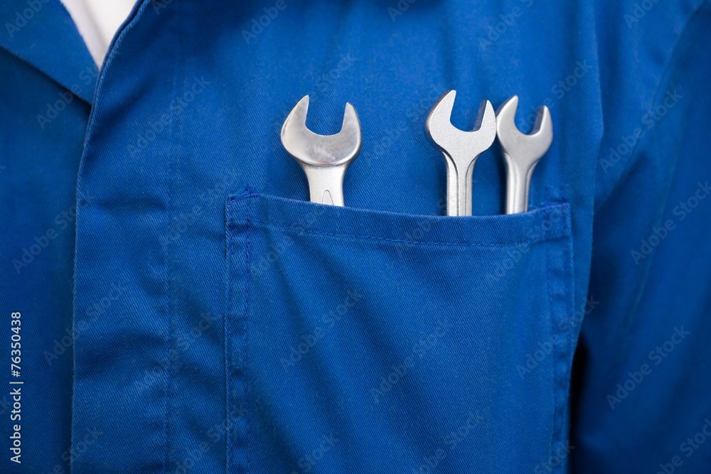 Mechanic with wrenches in pocket - obrazy, fototapety, plakaty 