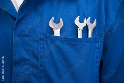 Mechanic with wrenches in pocket