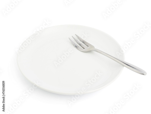 Knife and fork over the plate isolated