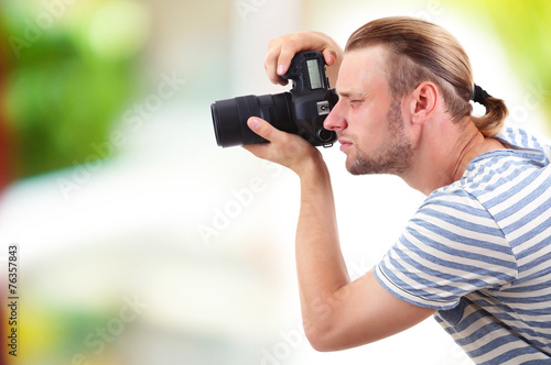 Young photographer taking photos outdoors