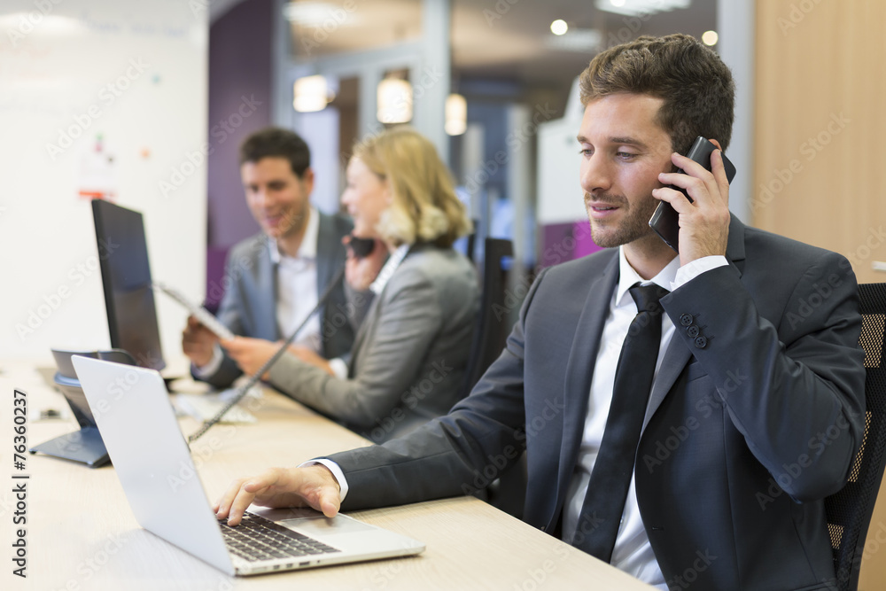 Businessman talking on the mobile phone in modern office Businessman talking on the mobile phone in modern office