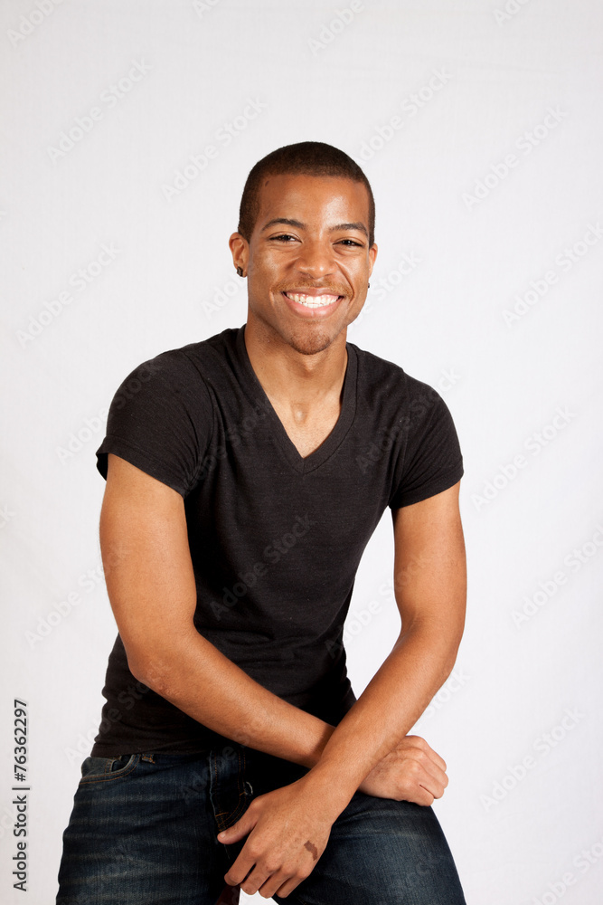 Black man in black shirt smiling at the camera Black man in black shirt smiling at the camera