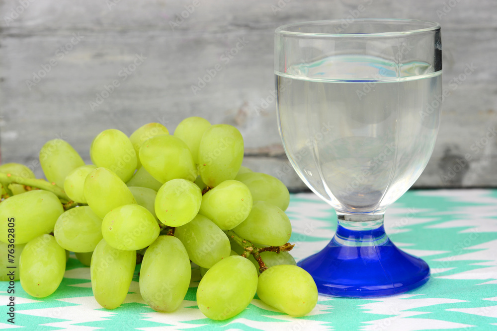 glass water of wine with green grapes glass water of wine with green grapes