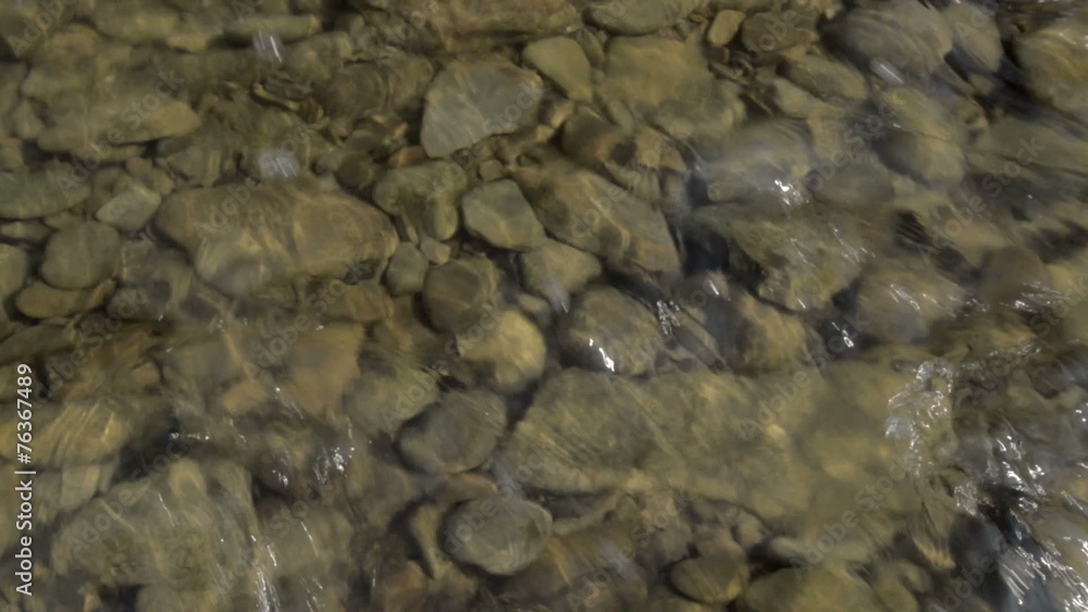 Shallow mountain San river flow sunny day.