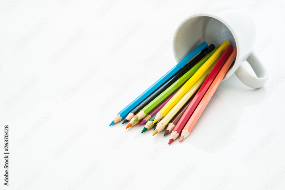 Naklejka premium stack of colored pencils on white background