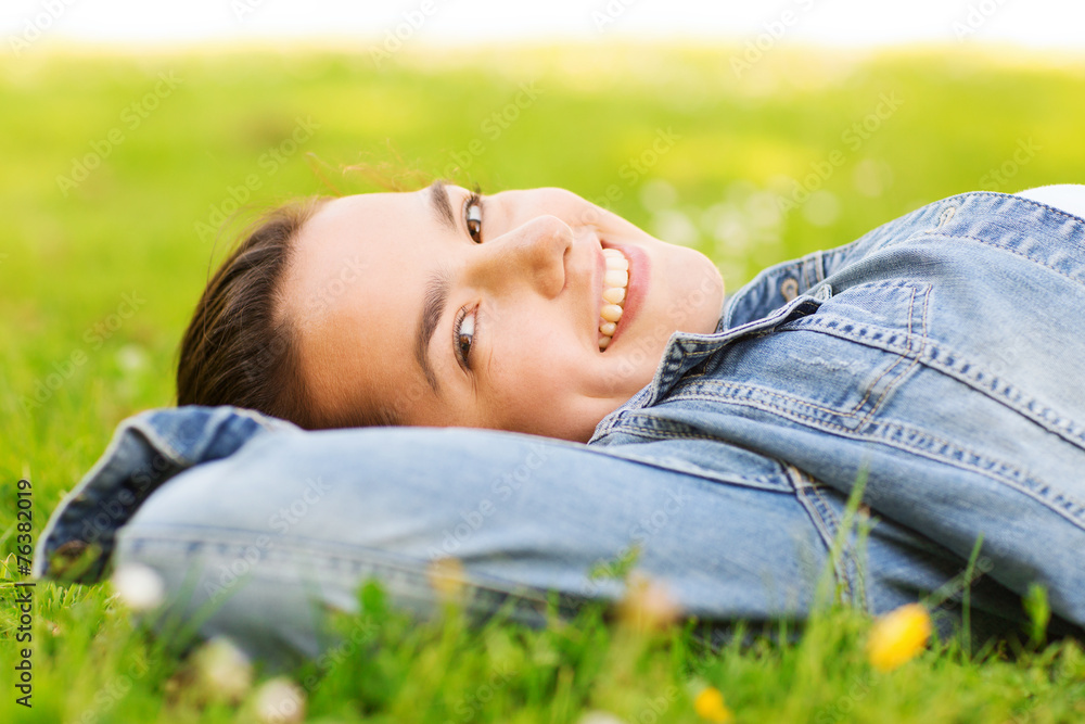 smiling young girl lying on grass smiling young girl lying on grass