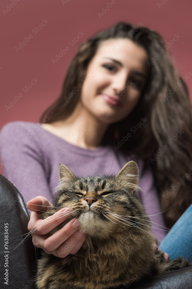 Young woman cuddling a cat
