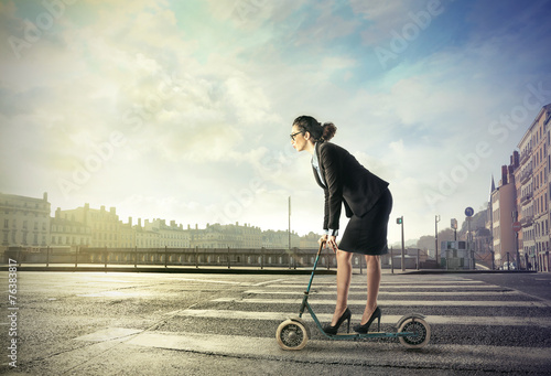 Businesswoman on a push scooter photo