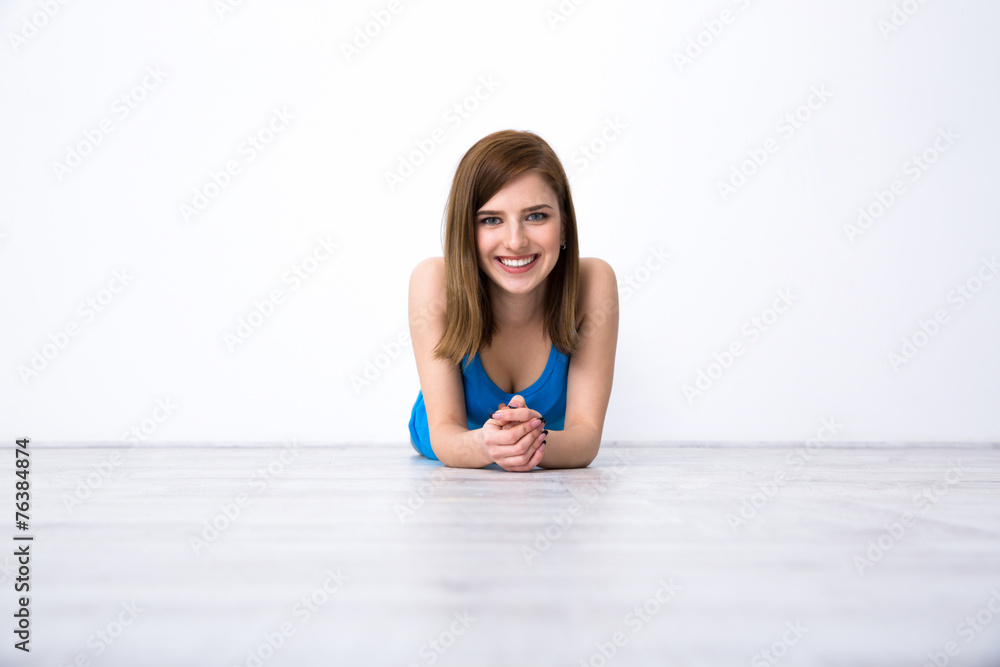 Portrait of a beautiful smiling woman lying on the floor Portrait of a beautiful smiling woman lying on the floor