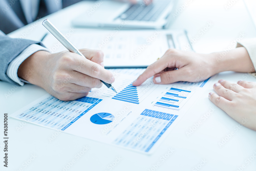 Business people discussing the charts and graphs showing the res Business people discussing the charts and graphs showing the res