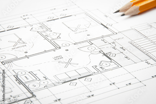 Construction blueprints on the worktable and yellow pencils © gargantiopa