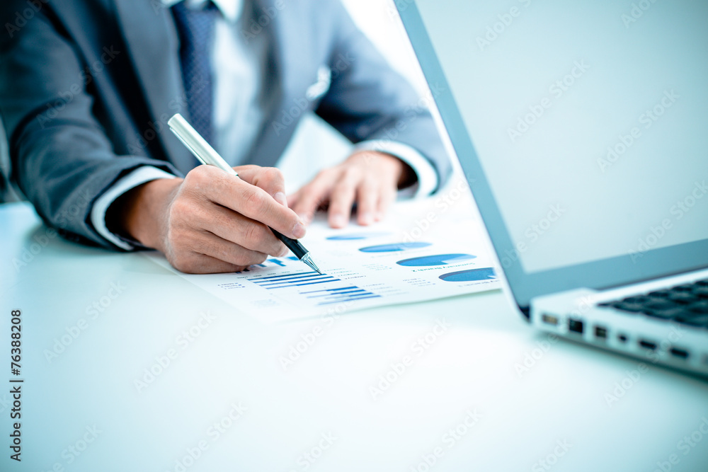 Business people discussing the charts and graphs showing the res Business people discussing the charts and graphs showing the res