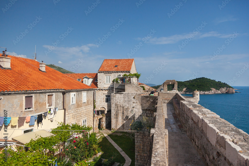 Old houses inside the city walls with Lokrum island Old houses inside the city walls with Lokrum island
