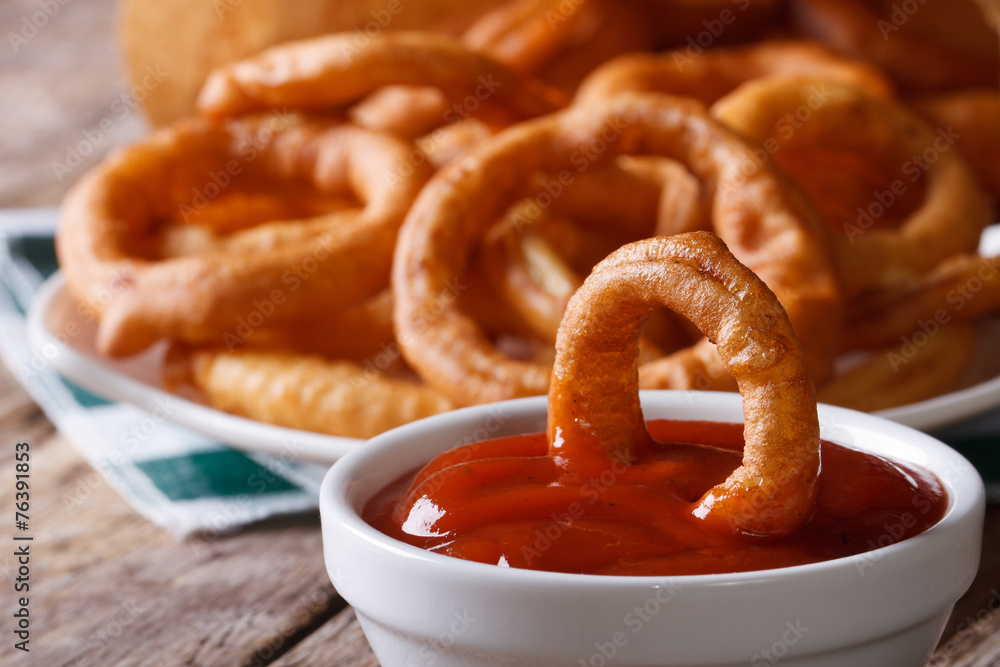 Deep-fried onion rings with ketchup macro. horizontal Deep-fried onion rings with ketchup macro. horizontal