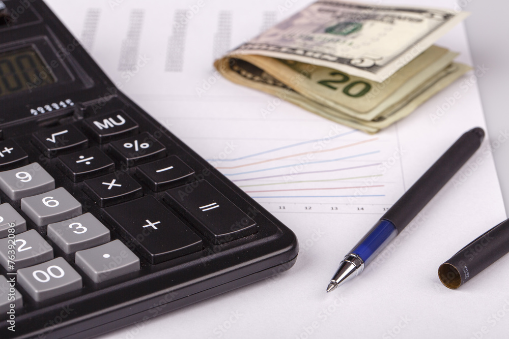 Business Charts with calculator, money and pen Business Charts with calculator, money and pen