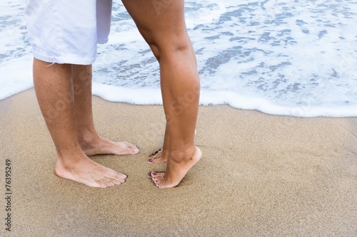 Couple feet on the beach