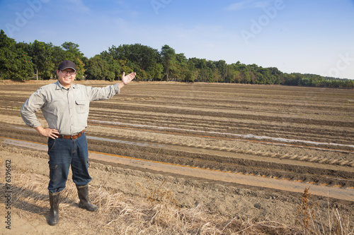 Farmer man showing his farming land