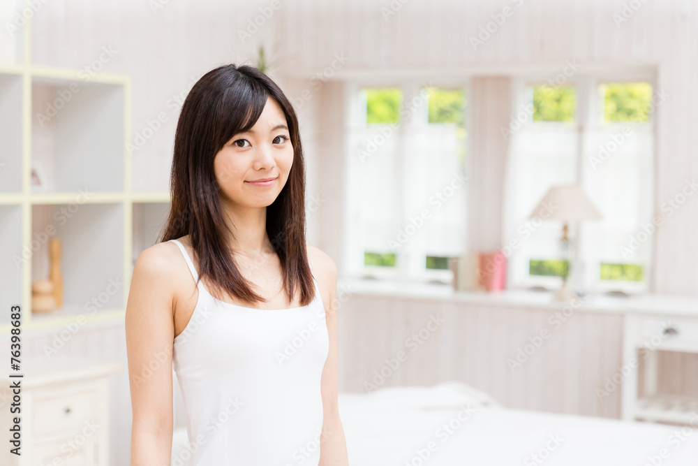 young asian woman relaxing in the bed room