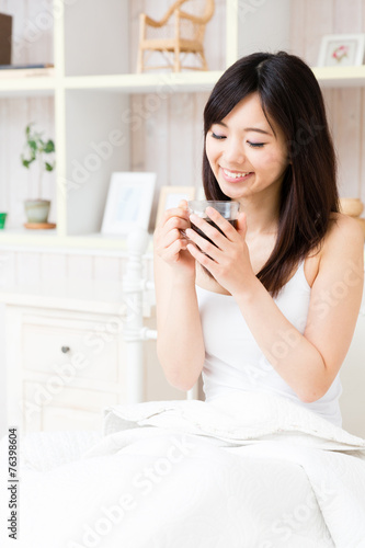 young asian woman relaxing in the bed room