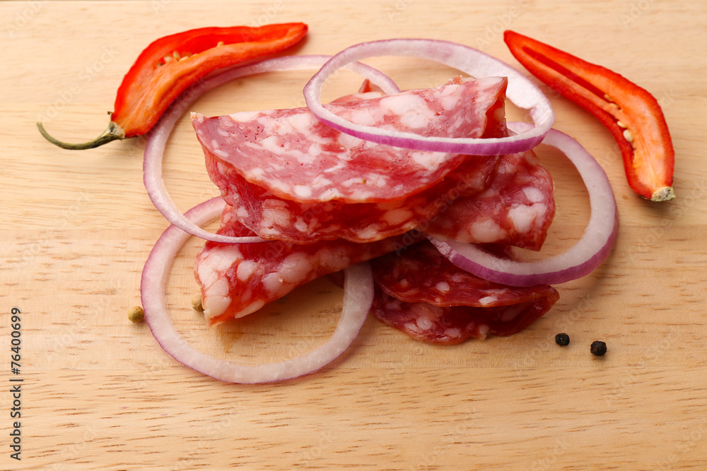 Sliced salami with chili pepper, onion and spices Sliced salami with chili pepper, onion and spices
