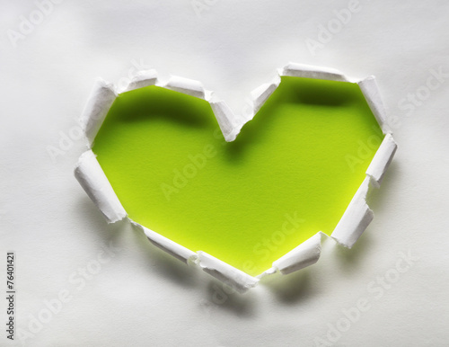 Torn paper heart over colorful background