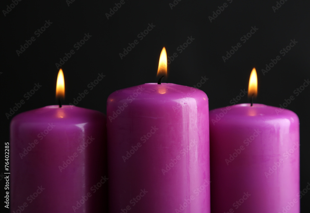 Purple candles on black background Purple candles on black background